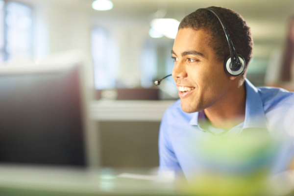 person talking on headset at computer